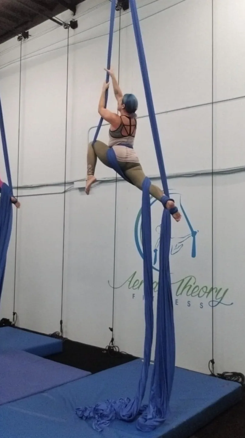 nurse ashley bowlin hanging from acro yoga ribbons