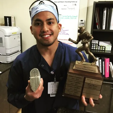 daniel diaz in office holding money and trophy