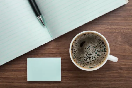 coffee and notebook on wooden table nurse retirement