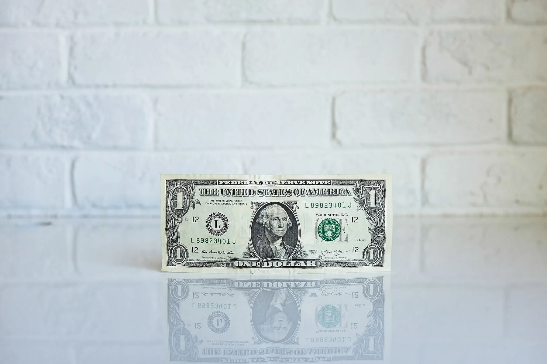 dollar against white background nursing school debt