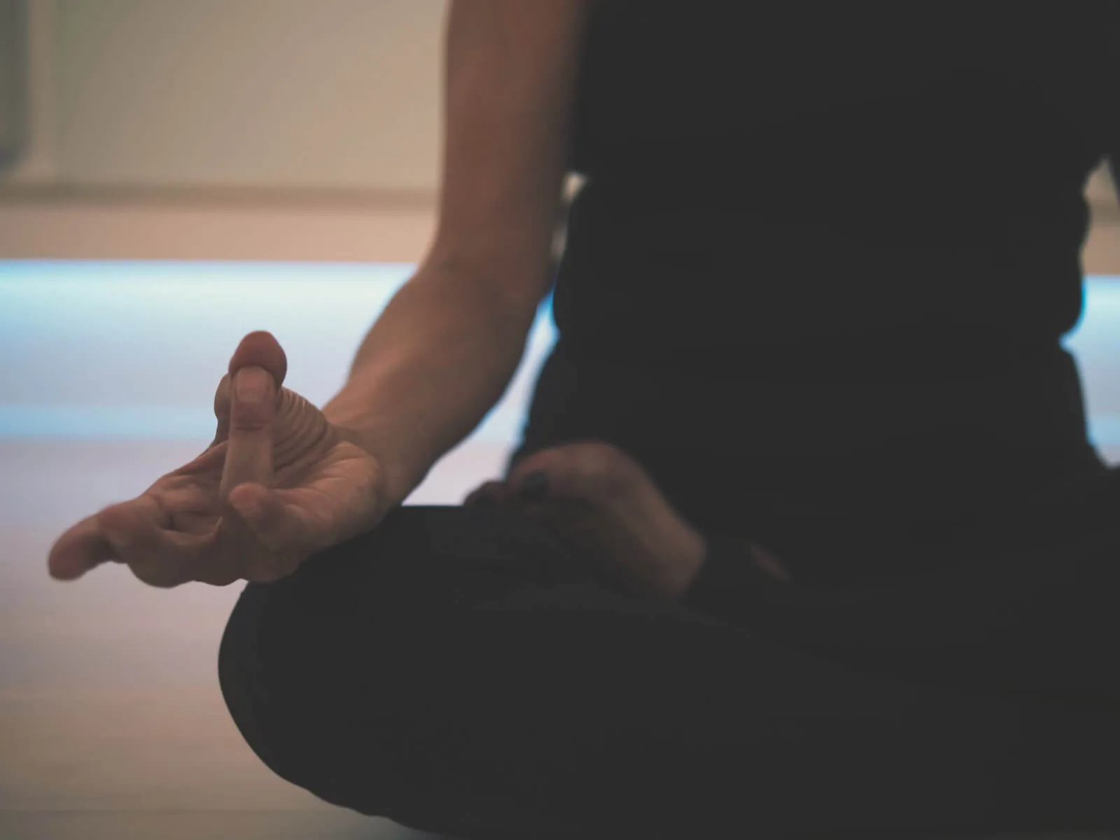 woman sitting on yoga mat meditating nurse wellness meditation