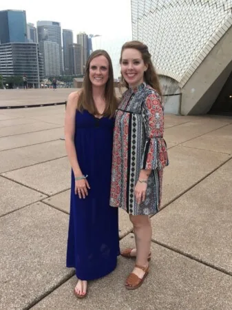 travel nurse duo nurses posing in front of modern building