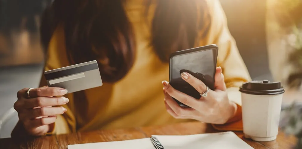 woman holding phone and credit card ordering online ecommerce nurses week discounts 2020 freebies