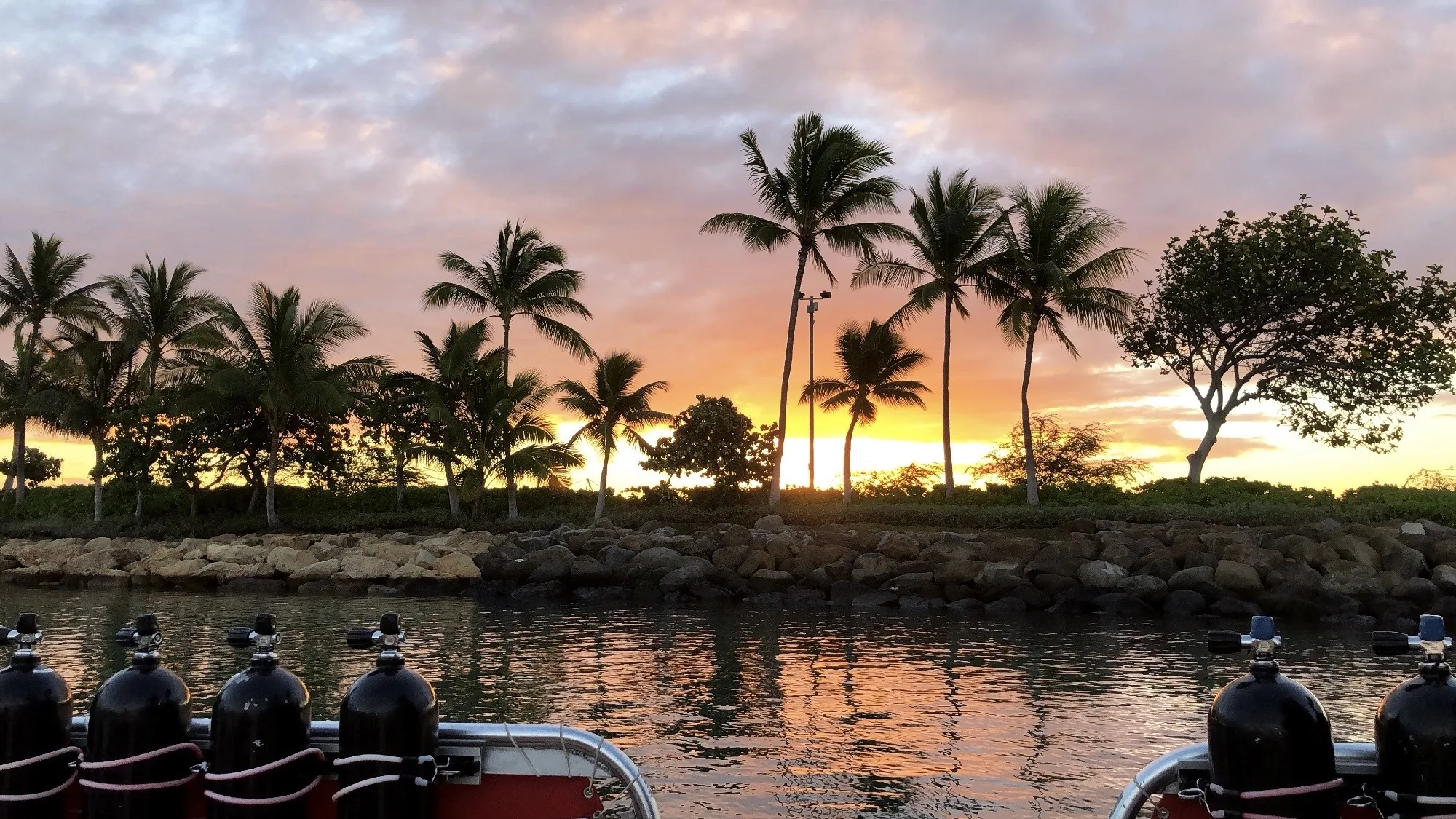 the sun setting over a bay