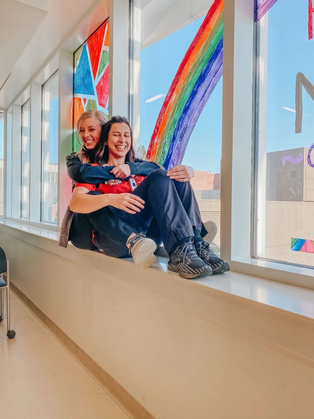 Two smiling nurses in a healthcare facility wearing Scope scrubs.