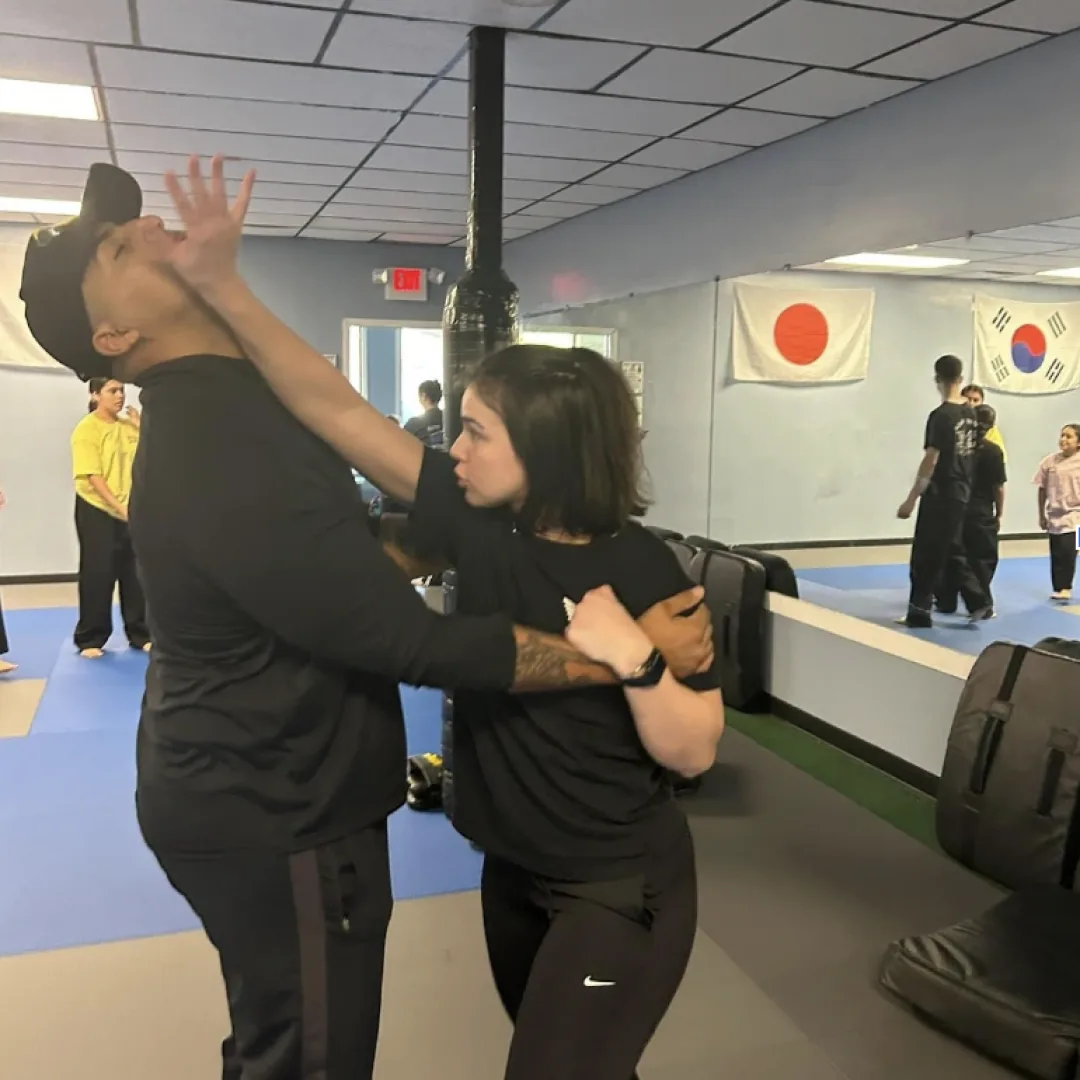 Photo of stef practicing Krav Maga self defense against another person.