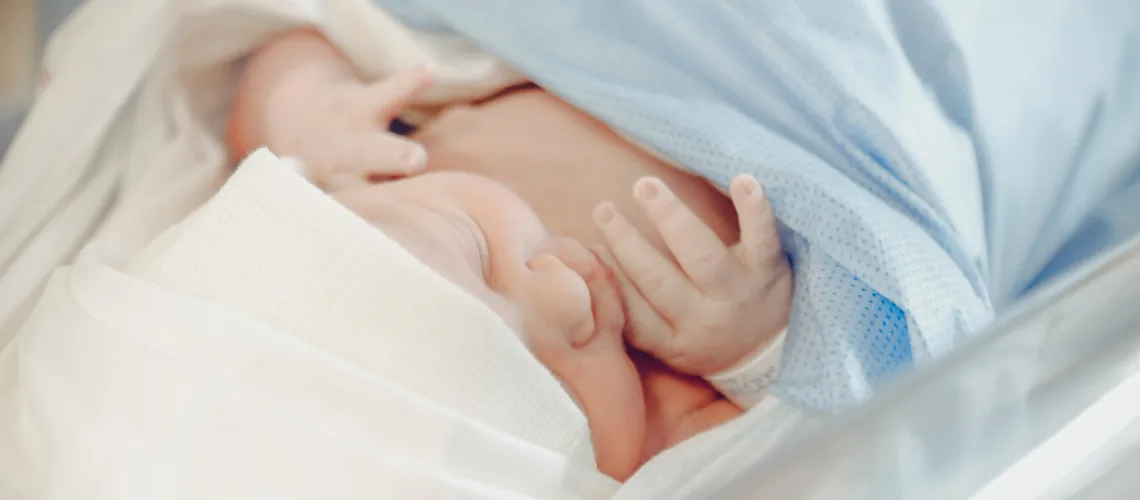 A peaceful newborn wrapped in a hospital blanket, nestled in a mother-baby unit's bassinet, capturing the tranquil moments of care and observation in the nurturing environment immediately after birth.